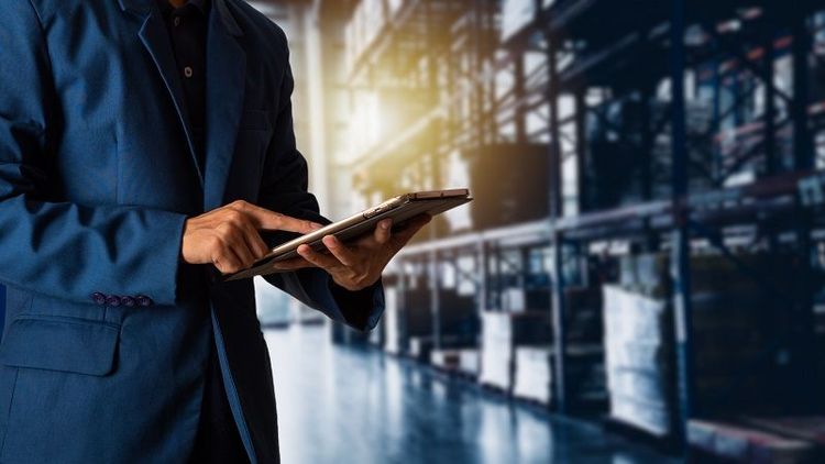 A_construction_worker_control_a_pouring_concrete_pump_on_construction_site_and_sunset_background