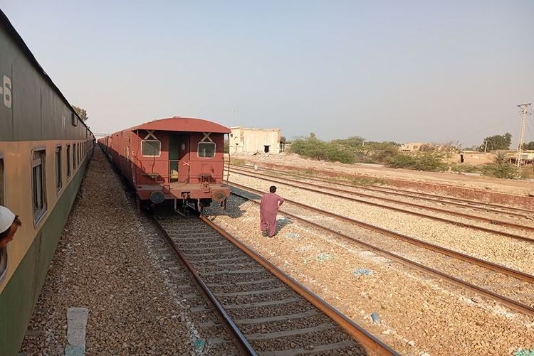 railway_station_under_construction_with_concrete_pillars_and_red_train