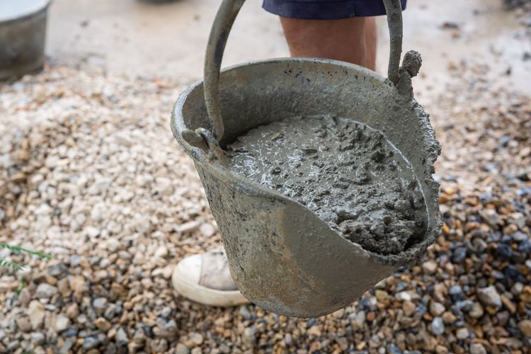 construction_technicians_mixing_cement_stone_and_sand_for_construction