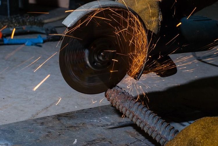 Male_workers_cut_and_weld_metal_with_spark.