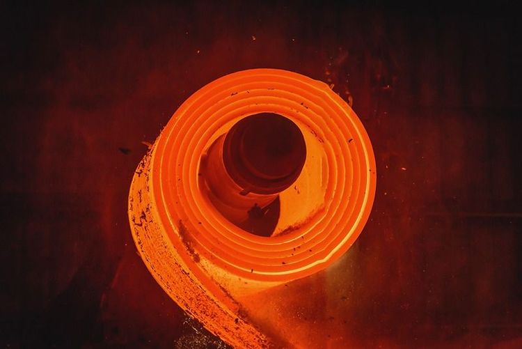 closeup_of_glowing_steel_coil_in_manufacturing_process