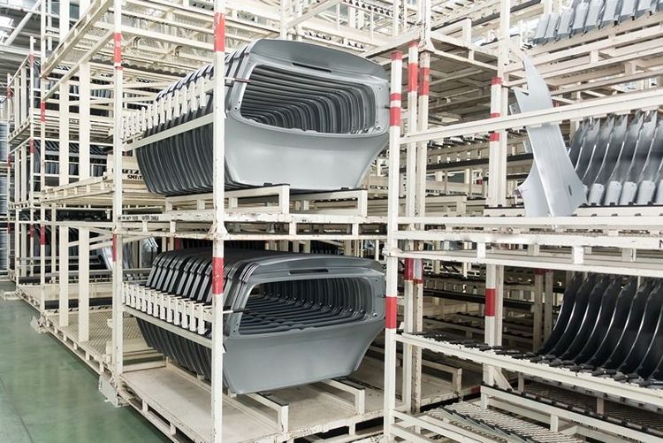 stacked_automotive_body_panels_in_organised_warehouse_racks