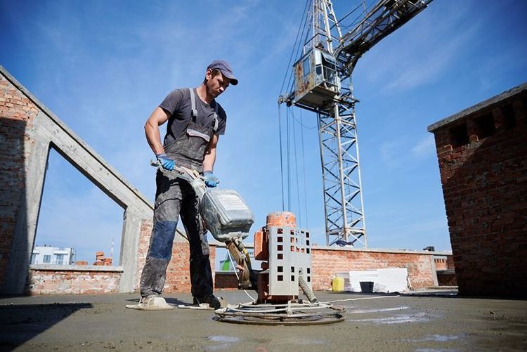 Worker_leveling_fresh_floor_with_special_machine